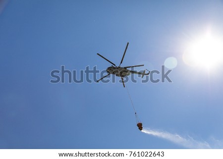 Similar – Image, Stock Photo A firefighting helicopter pours water into a forest to put out a forest fire