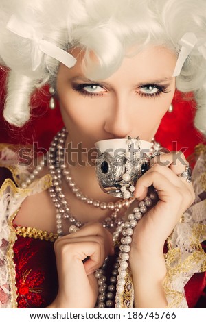 Beautiful Baroque Woman Portrait Drinking from a Cup - Baroque style portrait of a young beautiful woman drinking from a small cup
