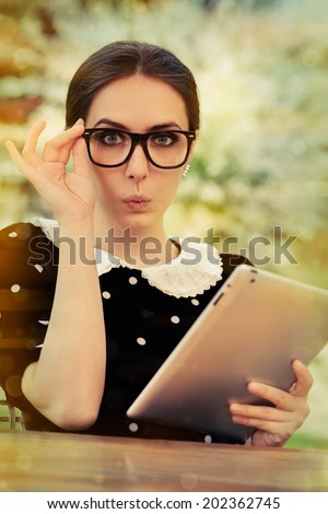 Surprised Young Woman with Glasses and Tablet - Beautiful woman with surprised expression holds a tablet computer