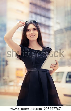 Young Woman with Tablet Out in the City - Woman wearing glasses, eyeglasses holding a PC tablet out in the city