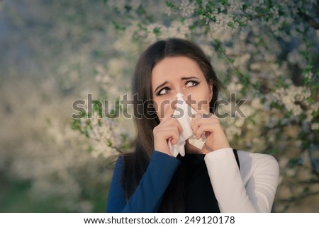 Girl with Spring Allergies in Floral Decor - Portrait of a sick woman blowing her nose