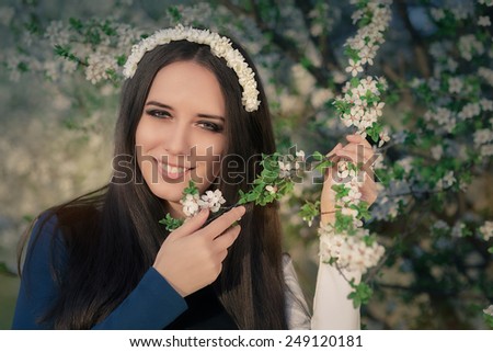 Portrait of a Happy Girl with Floral Wreath Outside - Close-up of a beautiful young woman outside wearing a floral headdress