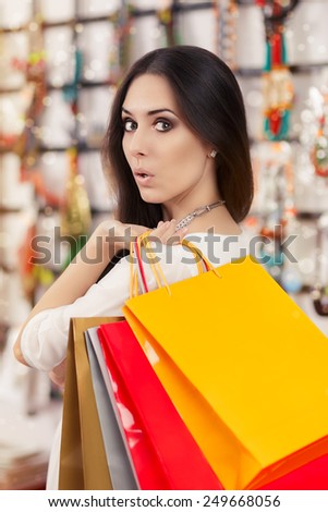 Surprised Beautiful Woman Shopping  - Portrait of a amazed young girl with shopping bags in trendy store