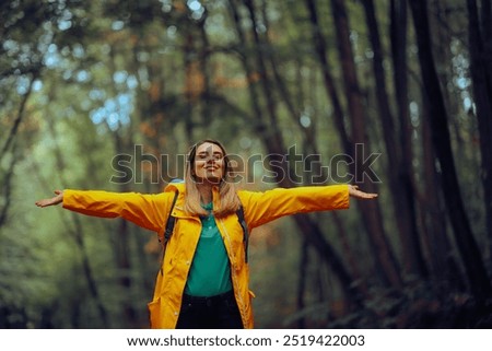 
Happy Woman Enjoying the Forest During Spring Season 
Carefree tourist relaxing outdoors feeling happiness and nature connection 
