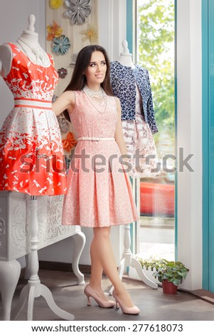 Woman in Pink Dress in Fashion Store - Portrait of girl in a clothes shop in a pink elegant dress