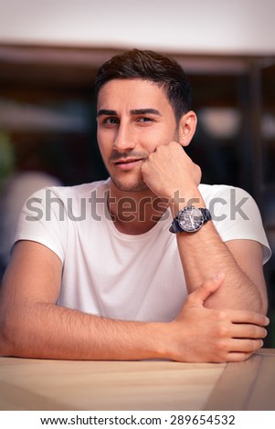 Young Man Sitting in a Restaurant - Portrait of a man wearing a watch waiting for his date