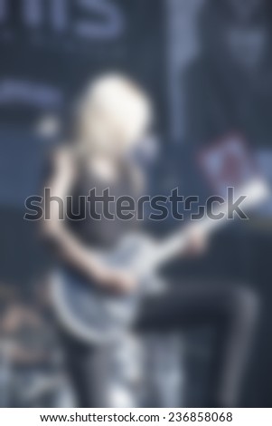 blurred woman  guitar player on concert stage