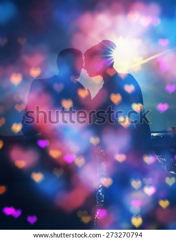 Silhouette couple over sunset ,heart bokeh background ,emotions and love concept,happiness