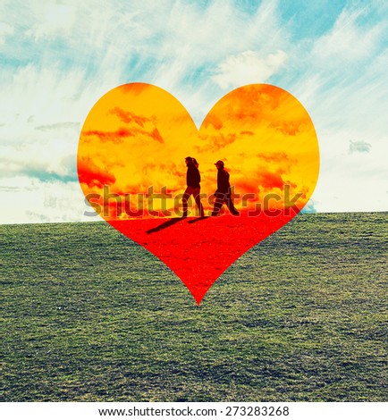 love couple walking on the top of the green hill ,big orange geart in the middle