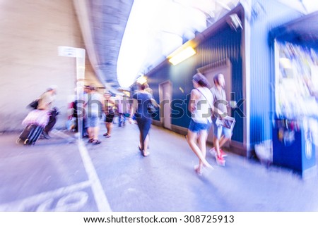 motion blurred people walking in metro station