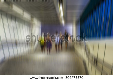 motion blurred people walking in metro station