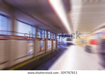 subway train in metro station with motion blurred people walking