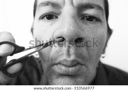 man trimming his nose hair with  scissors