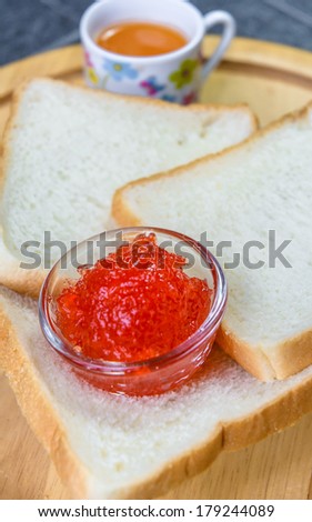strawberry jam with many bread on wood circle pattern background