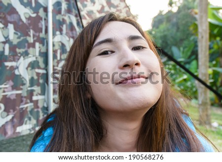portrait asia teenage girl happy cute and funny for the camera on a camping tent
