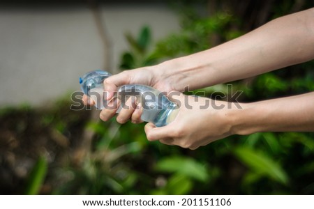 girl hand holding water balloon at blur natural background