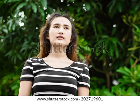 Happy  asia young woman in a natural tree at outdoor sunrise