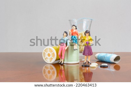 miniature woman people with sewing kit set concept business fashion