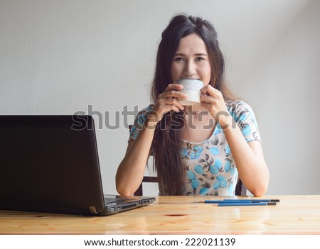 asian business woman working with laptop and drink coffee at table