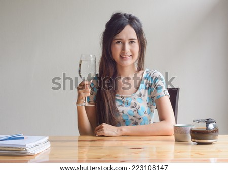 asian woman drink water and coffee at work table