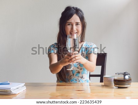asian woman drink water at work table