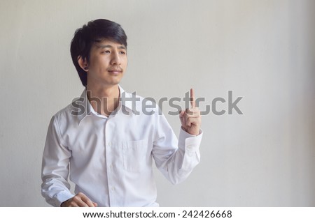 asia man pointing on it by his hand at copy space