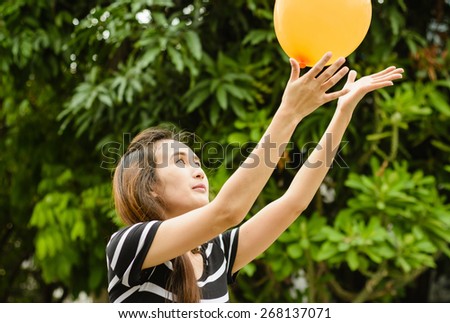 asia girl play color balloon at outdoor natural