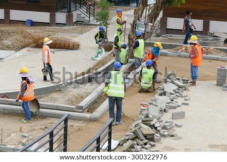Chiang Mai, Thailand - July 25, 2015: The workers are constructing pathway at the construction site in Nirotharam temple.