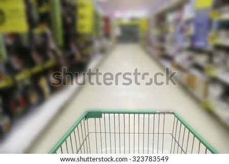 cart trolley in blurry defocused supermarket grocery store