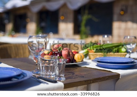 Still life with glass and fruits outdoors. Horizontal orientation. Shallow depth of field.