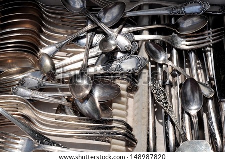 Aged and tarnished silver cutlery for sale at the flea market