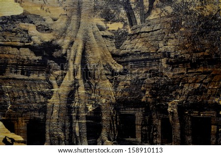 vintage style wood transfer image of the ta prom jungle temple in angkor,cambodia.lots of dirt,grunge and other blemishes in the image.the beauty of imperfection!