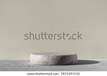 Monochrome gray template for mockup, banner. Flat round granite pedestal on textured background. Stone stand for natural design concept. Horizontal image, center composition, hard light, front view