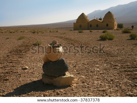 Deserted landscape with stones and the house in traditional Arabian style
