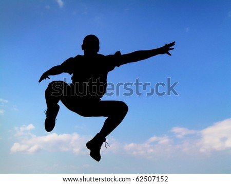Silhouette jumping man sky background
