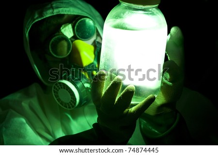 scientist holding glowing toxic substance