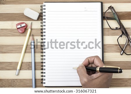 Close-up of pen on notebook business  on the wood