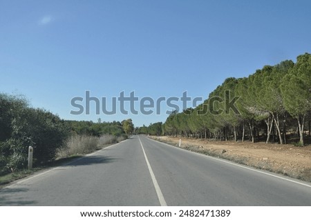 Similar – Foto Bild Leere Asphaltstraße inmitten eines schneebedeckten Feldes unter einem Himmel mit Nordlicht