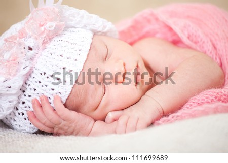 newborn baby (at the age of 14 days) sleeps in a knitted  hat