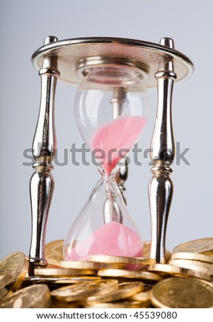 Time is money concept - hourglass and coins