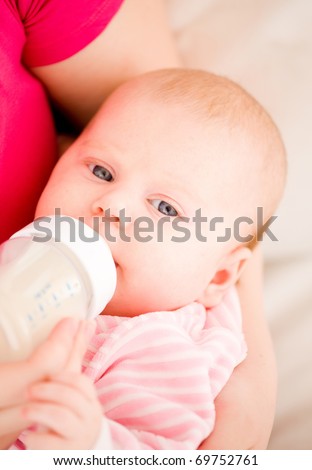 Feeding of the chest baby by a dairy mix from a children\'s small bottle