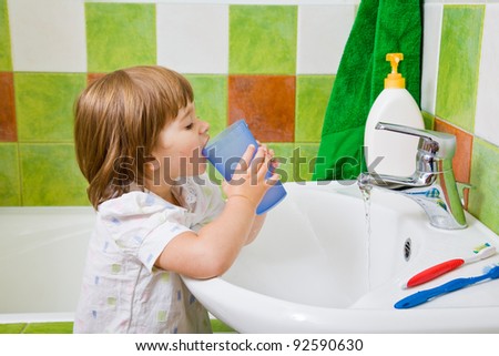 Personal hygiene. The little girl rinses a mouth after toothbrushing.