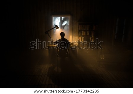 A realistic dollhouse living room with furniture and window at night. Man sitting on table in dark room. Concept of stay home during global virus pandemic. Selective focus. Сток-фото © 