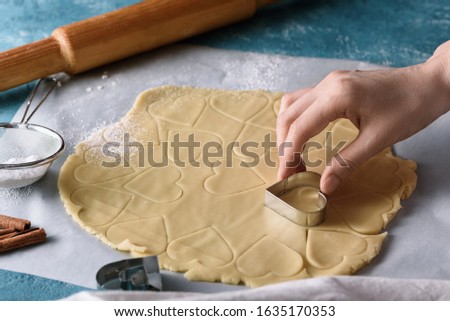process of making cookie dough heart shape on kitchen blue table, homemade cookies concept
