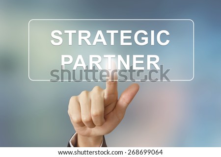 business hand pushing strategic partner button on blurred background