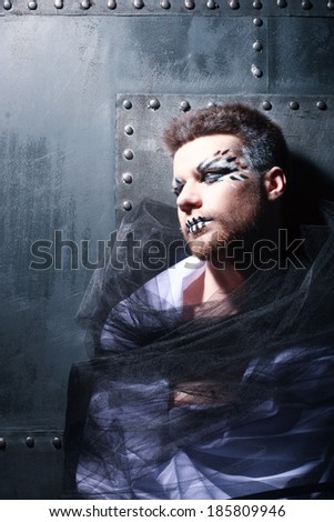 portrait of the youngportrait of the young man against an iron wall man against an iron wall