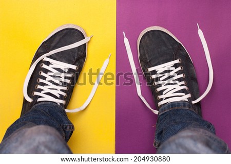 stylish blue gym shoes with white laces on a color background