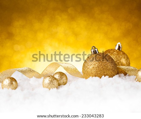 Golden christmas ball on glitter background. studio shot
