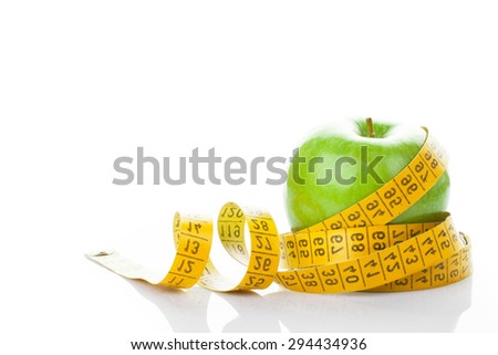 dieting, lose weight concept. apple with measuring tape