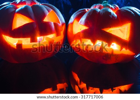 Smoking group Halloween pumpkins in dark light. studio shot